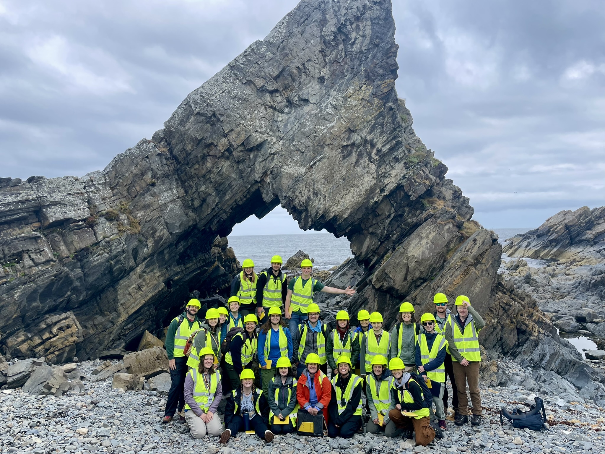 Students in front of a rock